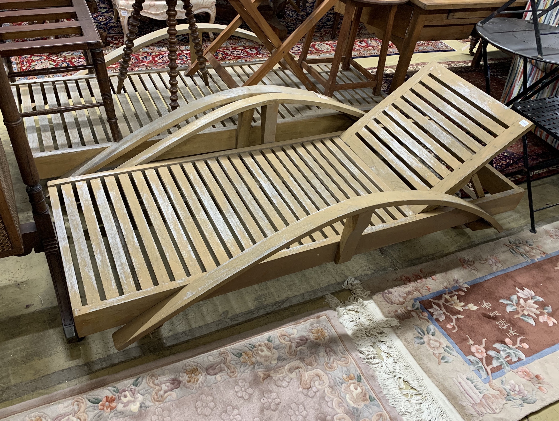 A pair of stained hardwood garden loungers, length 198cm, depth 82cm